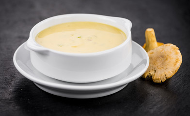 Creamy Chanterelle Soup on a vintage slate slab, selective focus