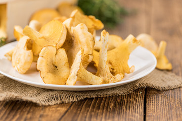 Portion of fresh harvested Chanterelles on wooden background