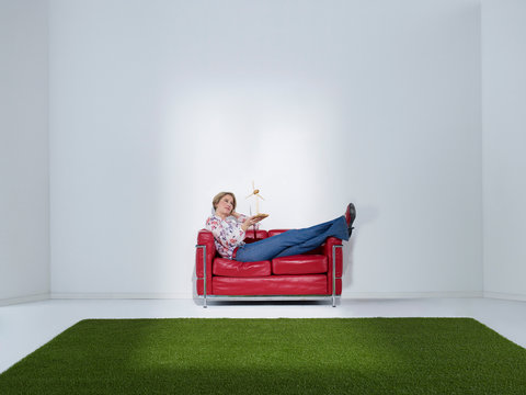 Woman Laying On Sofa With Windwheel