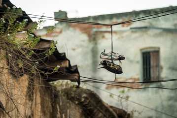 Old worn out shoes on a wire