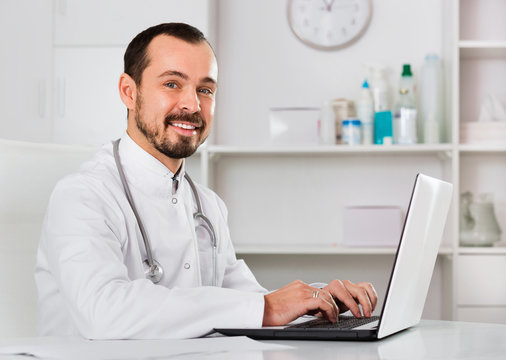 Man doctor working effectively in his office