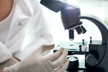 Young scientist using a microscope