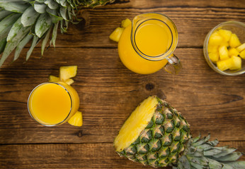 Fresh made Pineapple Juice on a rustic background