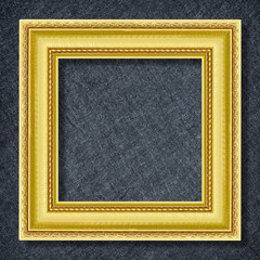 gold frame on Dark grey black slate background or texture.