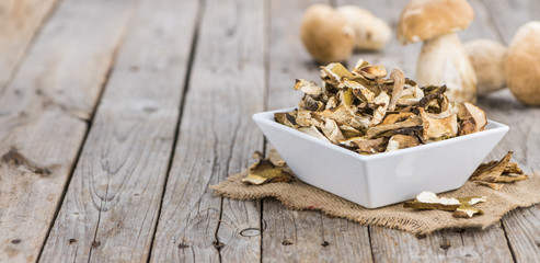 Dried Porcinis on vintage wooden background