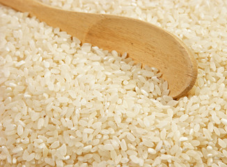 raw rice and wooden spoon