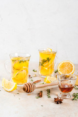 Fall and winter traditional drinks. Warming hot tea with lemon, ginger, spices (anise, cinnamon) and herbs (thyme), copy space