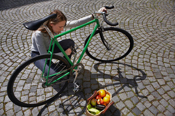 Woman checking up her bike