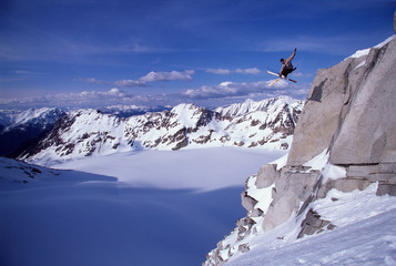 Skier jumping off a cliff