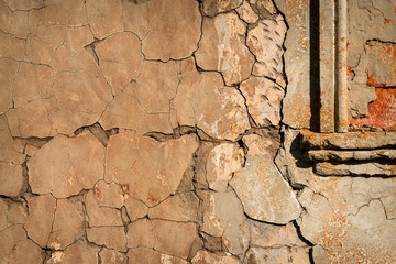 Wall with cracked plaster and part of the window