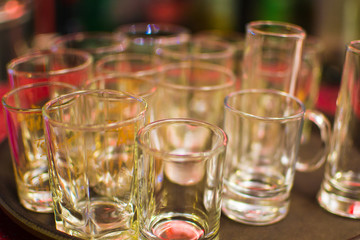 a lot of empty wine glasses on a tray