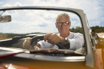 Senior man in sports car