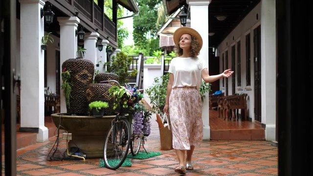 Fashionable Woman In Provence Style Sightseeing Outdoors In Hat And Floral Skirt. Slow Motion. 4K. 