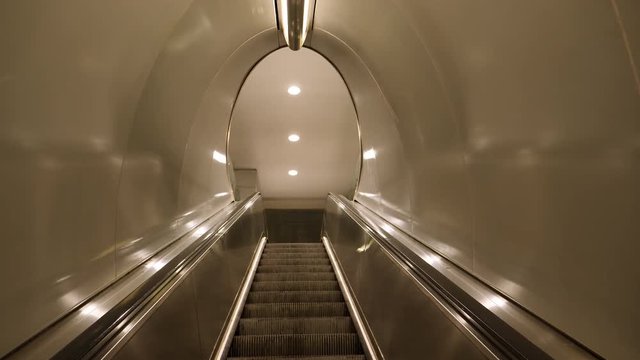 First Person Perspective Shot Taking The Underground Escalator.