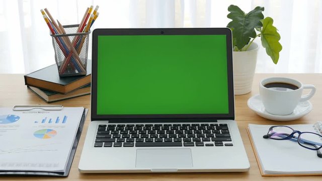 4K : A laptop computer with a key green screen.