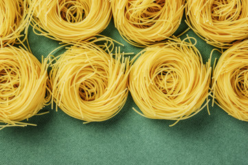 Tagliatelle pasta on a green background