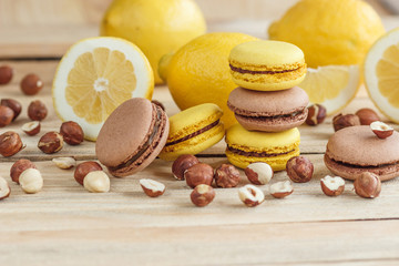 Yellow and brown french macarons with lemon and hazelnuts