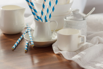 Set of white empty tableware with striped tubules