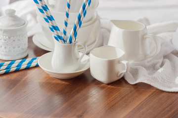 Set of white empty tableware with striped tubules