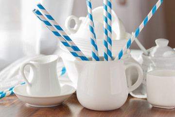 Set of white empty tableware with striped tubules