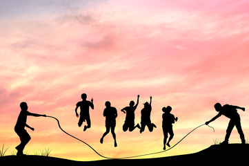 Silhouette of grooup people rope jumping with in twilight, teamwork and team concept .