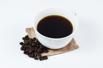 Black coffee in white cup and coffee beans