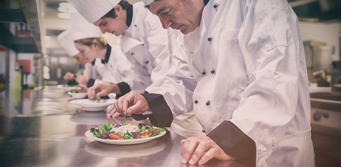 Obraz na płótnie Canvas Chefs preparing their salads 