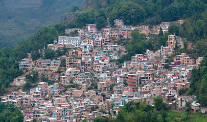 Fototapeta premium Village over terraced rice fields in Yuanyang, Yunnan, China
