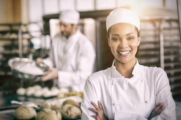 Happy female baker smiling at camera