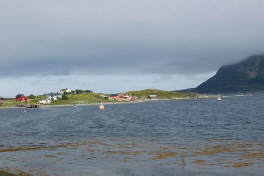Inhabited peninsula with typical houses on the Porsangerfjorden 