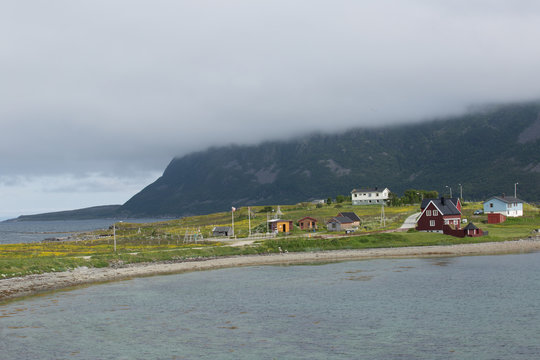 Inhabited peninsula with typical houses on the Porsangerfjorden 