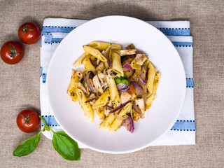 Pasta with pesto sauce and nuts on a the table
