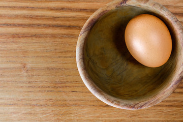 Fresh, raw chicken eggs on an oak tray. A place for a label.