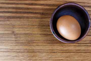 Fresh, raw chicken eggs on an oak tray. A place for a label.