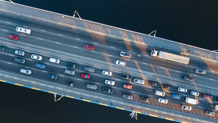 Aerial top view of bridge road automobile traffic jam of many cars from above, city transportation...