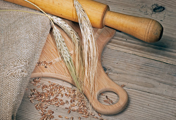 Fototapeta na wymiar rye bread, and corn on a wooden table