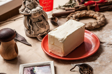 Butter on red plate on table covered with wrapping paper