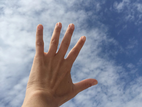 hand against blue sky