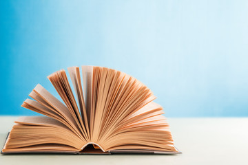 an open hardcover book on a blue background