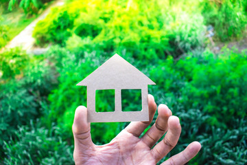 holding home peper on tree blurry background.using wallpaper or background for education, business...