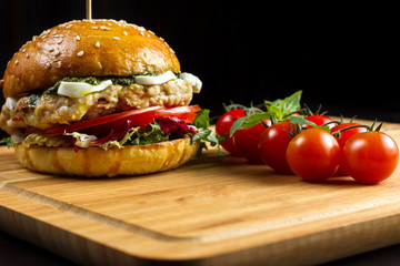 Hamburger with cheese on a bamboo dash.