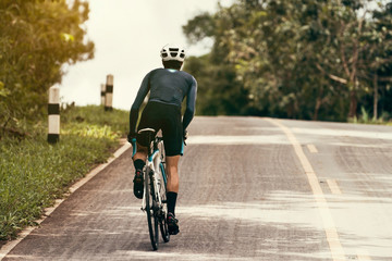 Obraz premium Cyclists are cycling, climbing up to the top.