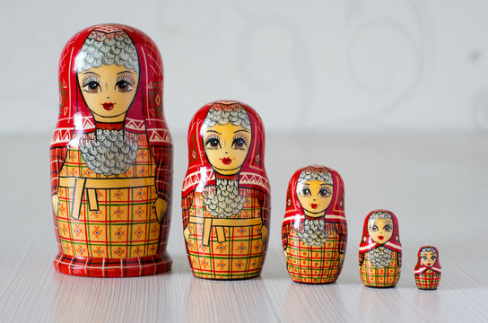Five red matryoshka. Blurred background