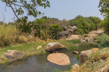 fluent river with rocks and vegetation in Africa. Lubango. Angola.