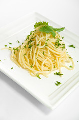 Italian food Bolognese Pasta / Spaghetti meal with basil leaves on a plate isolated on white background
