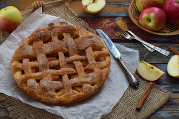 Homemade organic apple pie from yeast dough on wooden background. Fruit dessert ready to eat
