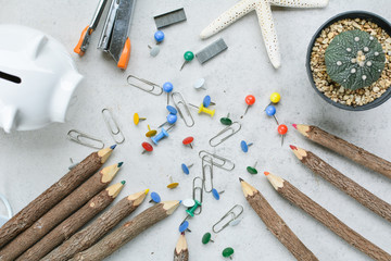 group of office equipment color pencil paper pins and clips on table