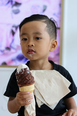 Asian boy Eating ice cream happily © KanyaphatStudio