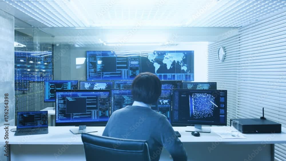 Poster In the System Control Data Center Technician Operates Multiple Screens with Neural Network and Data Mining Activities. Room is Light and Full of Monitors with Working Neural Network on Them.