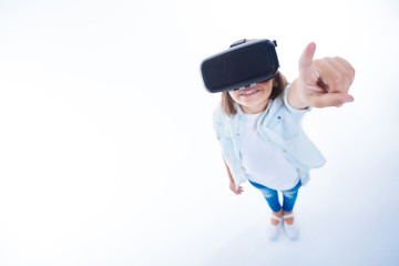 Joyful pretty girl pointing with her finger